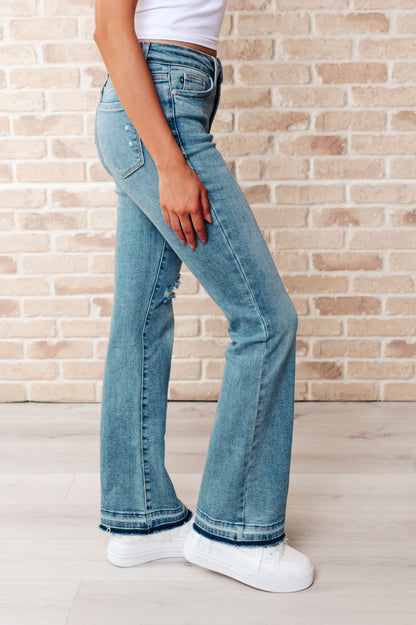 Judy Blue • Isla • Mid Rise Distressed Released Hem Bootcut Jeans